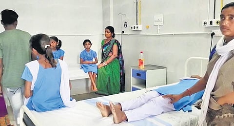 A child vomiting after eating the noon meal and (right) students admitted to the district headquarters hospital. (Photo | Express)