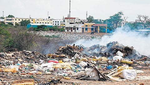 Garbage being set on fire near Konakarai micro compost centre in Tiruchy. (Photo | M K Ashok Kumar,EPS)