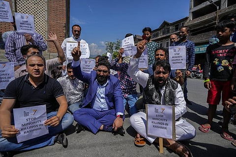 Members of JK Awami Aawaz Party hold placards as they take part in a protest against minority killings in Srinagar. (Photo | AP)