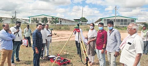 Revenue Department officials of Medak district conduct land survey at Jamuna Hatcheries in Achampeta village (Photo | EPS)