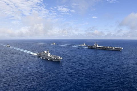 U.S. nuclear-powered aircraft carrier USS Ronald Reagan(R) and South Korea's landing platform helicopter ship Marado(L) sail during a joint military exercise at an undisclosed location. (Photo | AP)