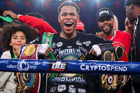 Devin Haney, center, of the United States, poses with his belts after defeating Australia's George Kambosos in their WBC lightweight title fight in Melbourne. (Photo| AP)