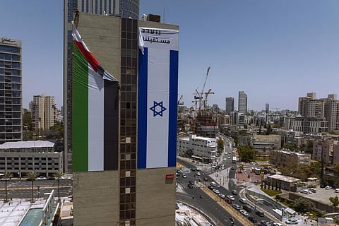 A Palestinian flag is removed from a building by Israeli authorities after being put up by an advocacy group that promotes coexistence between Palestinians and Israelis. (Photo | AP)