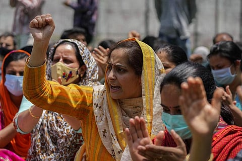 Kashmiri Hindus protesting against the killing of a Hindu female teacher by suspected rebels shout slogans in Srinagar. (Photo | AP)