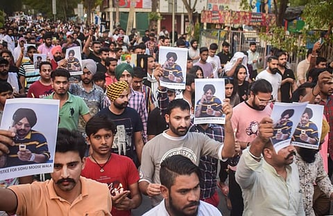Young men take out a candle march to pay tribute to Punjabi singer Sidhu Moose Wala, in Gurugram. (Photo | PTI)