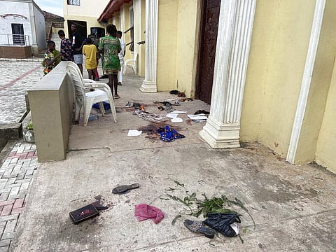 People stand outside the St. Francis Catholic Church in Owo Nigeria, Sunday, June 5, 2022. (Photo | AP)