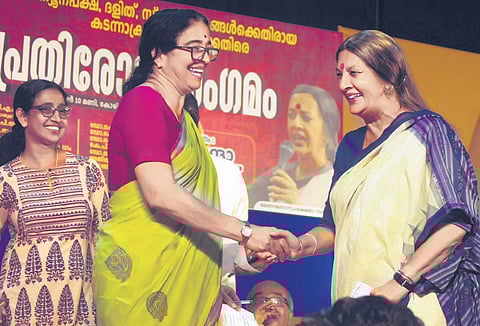 Kozhikode mayor Beena Philip receiving CPM PB member Brinda Karat at the venue of a protest meet organised in Kozhikode on Sunday | E Gokul