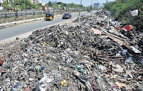 Heaps of garbage, including construction waste, dumped along the service roads on Maduravoyal bypass | P Jawahar