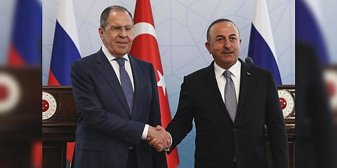 Russian Foreign Minister Sergey Lavrov, left, and Turkish Foreign Minister Mevlut Cavusoglu shake hands at the end of a joint news conference in Ankara, Wednesday, June 8, 2022. (AP Photo)