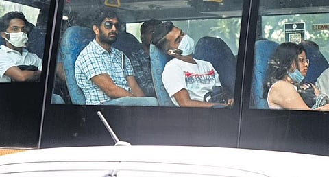 Passengers put on their masks at a BMTC bus amid a slight rise in Covid cases in Bengaluru on Tuesday | VINOD KUMAR T