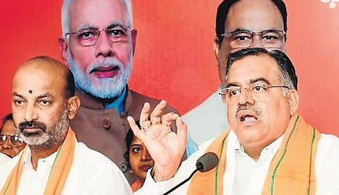 Flanked by BJP State president Bandi Sanjay, party TS in-charge Tarun Chugh makes a point during his presser at Nampally in Hyderabad on Wednesday