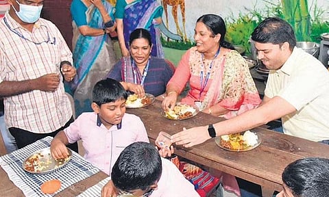 District Collector Jafar Malik having mid-day meal with children of Government Lower Primary School, Thrikkakara, on Wednesday