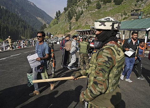 Soldiers stand guard as Hindu devotees begin the Amarnath Yatra annual pilgrimage to to an icy Himalayan cave, in Chandanwari, Pahalgam. (Photo | AP)