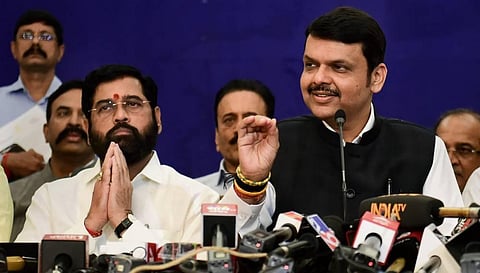Deputy CM and BJP leader Devendra Fadnavis speaks as Maharashtra CM and Shiv Sena leader Eknath Shinde looks on during a press conference, in Mumbai. 