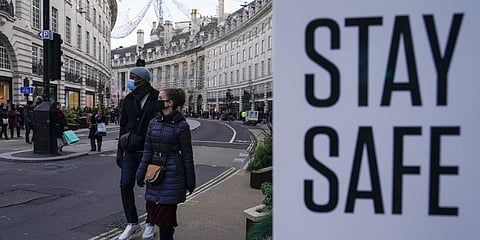 People wear face masks as they walk, in Regent Street, in London.(File Photo | AP)