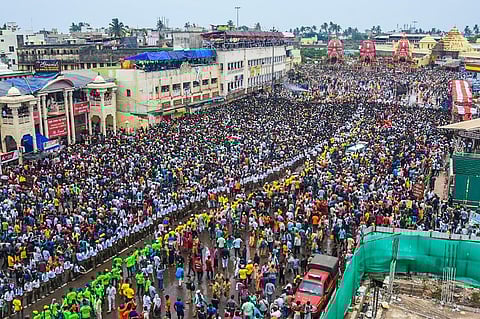Devotees throng the chariots of Lord Jagannath, Lord Balabhadra and Goddess Subhadra during the annual Rath Yatra of Lord Jagannath, in Puri. (Photo | Biswanath Swain, EPS)