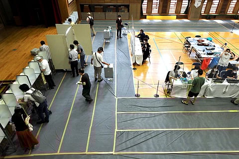 People vote during Japan's upper house election at a polling station in Tokyo. (Photo | AFP)