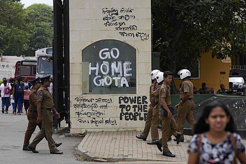 Police officers and people walk past a vandalised entrance to the president's official residence in Colombo, Sri Lanka, Sunday, July 10, 2022. (Photo | AP)