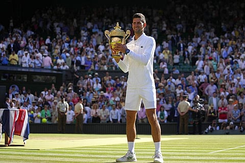 Serbia's Novak Djokovic holds the winners trophy as he celebrates after beating Australia's Nick Kyrgios to win the final of the men's singles. (Photo | AP)