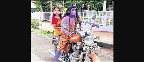Birinchi Bora staged a street play dressed in Lord Shiva costume to protest against rising fuel prices and other issues. (Photo | EPS)