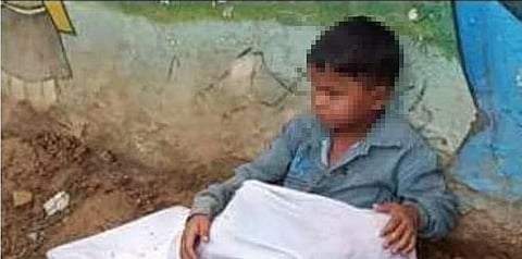 At an age when kids play with toys, Gulshan sat on the roadside with toddler brother’s body in lap. (Photo | Special Arrangement)