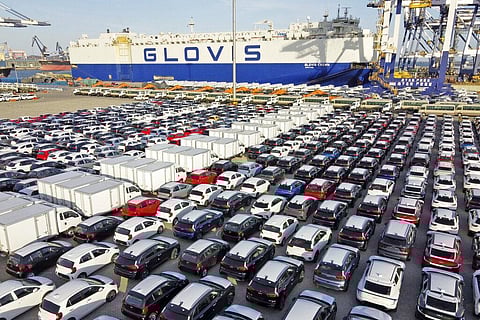 Cars and trucks for export are parked at a port in Yantai in eastern China's Shandong Province. (Photo | AP)