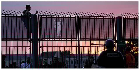 A fan stands on the fence in front of the Stade de France prior the Champions League final soccer match between Liverpool and Real Madrid, in Saint Denis near Paris, Saturday, May 28. (FilePhoto | AP)