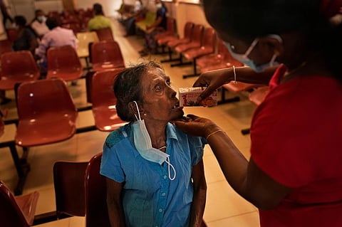 Mudiyansege Chandrawathi, a cancer patient, drinks a beverage after attending a medical clinic at the national cancer hospital in Maharagama, a suburb of Colombo, Sri Lanka. (File Photo | AP)