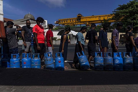 People wait in a queue with empty cylinders to buy domestic gas at a distribution center, in Colombo, Sri Lanka, Tuesday, July 12, 2022. (Photo | AP)