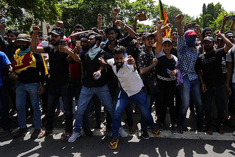 Protesters shout slogans before storming the Sri Lankan Prime Minister Ranil Wickremesinghe's office, demanding he resign. (Photo | AP)