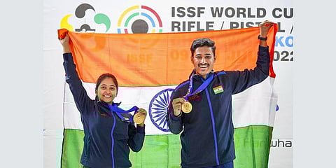 Indian shooters Mehuli Ghosh and Shahu Tushar Mane atop the podium pose with their medals and the national flag.(Photo | PTI)
