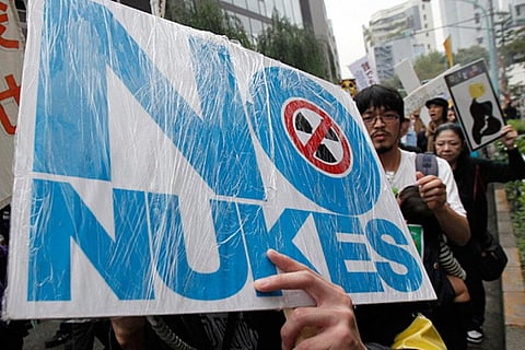 A protestor shows a no-nuke image as they march during an anti-nuclear power demonstration in Tokyo, Japan. (File Photo | AP)