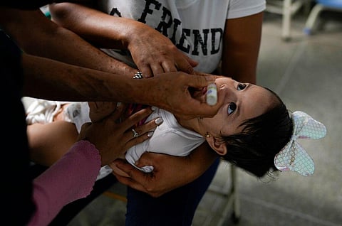 A toddler is inoculated for polio during a free vaccination campaign for polio, rubella and influenza organized by the Health Ministry in Caracas, Venezuela, on June 18, 2022. (Photo | AP)