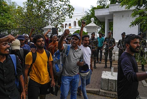 Protesters shout slogans as they leave prime minister Ranil Wickremesinghe's office building in Colombo, Sri Lanka, Thursday, July 14, 2022. (Photo | AP)