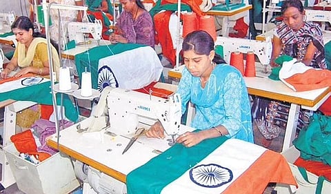 Workers stitch khadi flags at the flag-making unit in Bengeri, Hubballi | D Hemanth