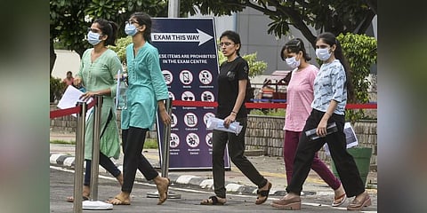 Students arrive to write the NEET examination at Jain College in Bengaluru on Sunday. 