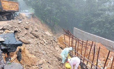 Workers repair a road obstructed by a landslide at Gerusoppa on NH-69. (Photo| EPS)