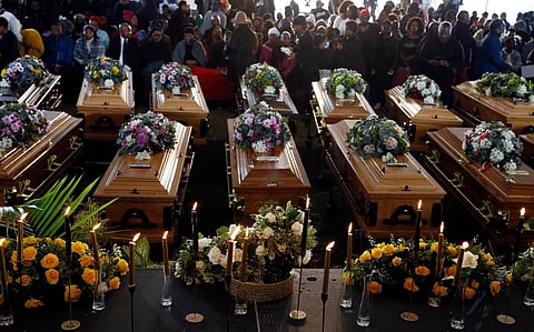 Coffins of 21 teenagers who died in a mysterious tragedy at a nightclub in the early hours of June 26, 2022 are lined up during their funeral held in Scenery Park, East London, South Africa. (Photo |