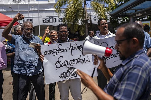 Trade union representatives and activists shout slogans during a protest against Sri Lanka’s acting president Ranil Wickremesinghe in Colombo. (Photo | AP)