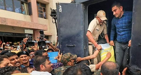 An accused in Kanhaiya Lal killing case being taken back to custody after he was produced at an NIA court, in Jaipur, Saturday, July 2, 2022. (Photo | PTI)