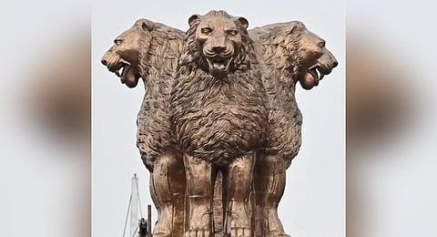 The national emblem of India on top of the new Parliament building 
