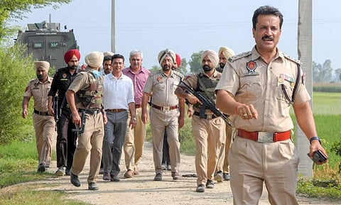Punjab DGP Gaurav Yadav along with police personnel at the site of an encounter in which two gangsters Jagroop Singh Roopa and Manpreet Singh alias 'Mannu Kusa' were killed. (Photo | PTI)