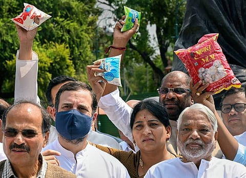Congress MP Rahul Gandhi with Adhir Ranjan Chowdhury and other opposition MPs during a protest against inflation and the decision to increase GST on food items. (Photo | PTI)