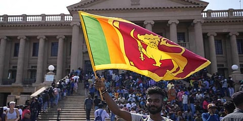A protester waves Sri Lankan national flag. (Photo | AP/PTI)