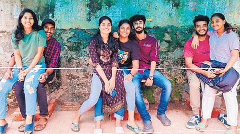 Students of CET sharing seats at a public waiting shed in Thiruvananthapuram