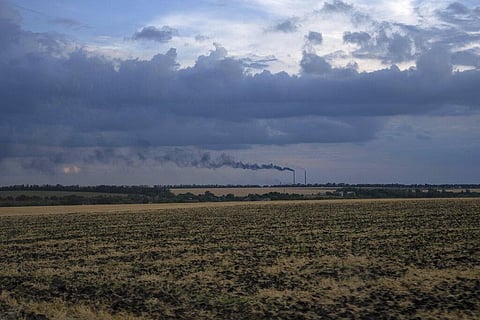 Grain fields backdropped by a power plant in Donetsk region, eastern Ukraine. (Photo |AP)