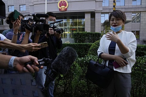 Teresa Xu speaks to journalists before her court session at the Chaoyang People's Court in Beijing, China on Sept. 17, 2021. (Photo | AP)