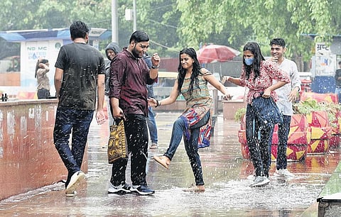 Delhi residents enjoy the light showers that brought relief from heat and humidity on Friday | parveen negi