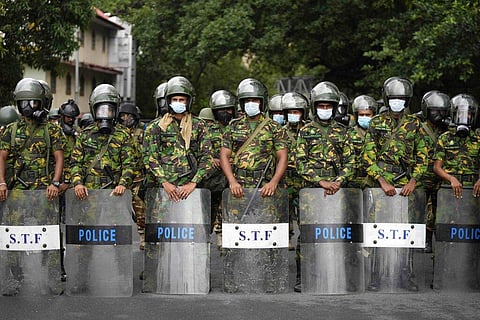 Police commandos stand guard at a barricade outside president's office in Colombo, Sri Lanka. (Photo | AP)