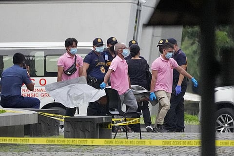 Funeral workers carry a victim's body at the Ateneo de Manila University in Quezon city, Philippines. (Photo | AP)